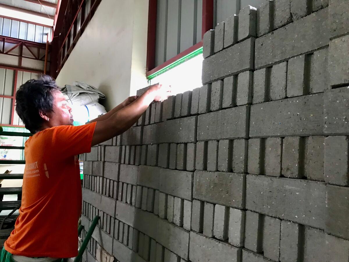 Bricks made partially from used plastic sachets are positioned at the Philippine Alliance for Recycling and Materials Sustainability recycling facility in Para?aque, a suburb of Manila.