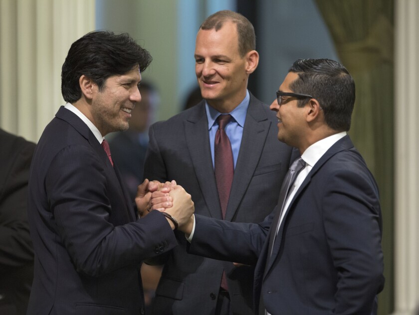 California Senate President Pro Tem Kevin de León, left, Assemblyman Kevin McCarty and Assemblyman Miguel Santiago shake hands after a measure to restrict the sale of ammunition was approved by the Assembly.