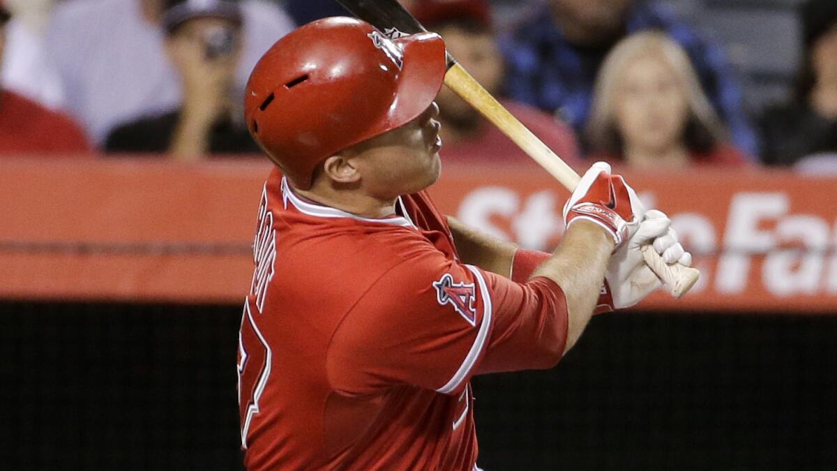 Angels center fielder Mike Trout hits a run-scoring single during the fifth inning of the Angels ' 9-3 win over the Houston Astros on Tuesday.