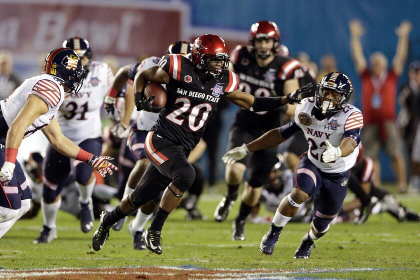San Diego State's Rashaad Penny returns a kick against Navy during the first half of the Poinsettia Bowl. The Midshipmen beat the Aztecs, 17-16.