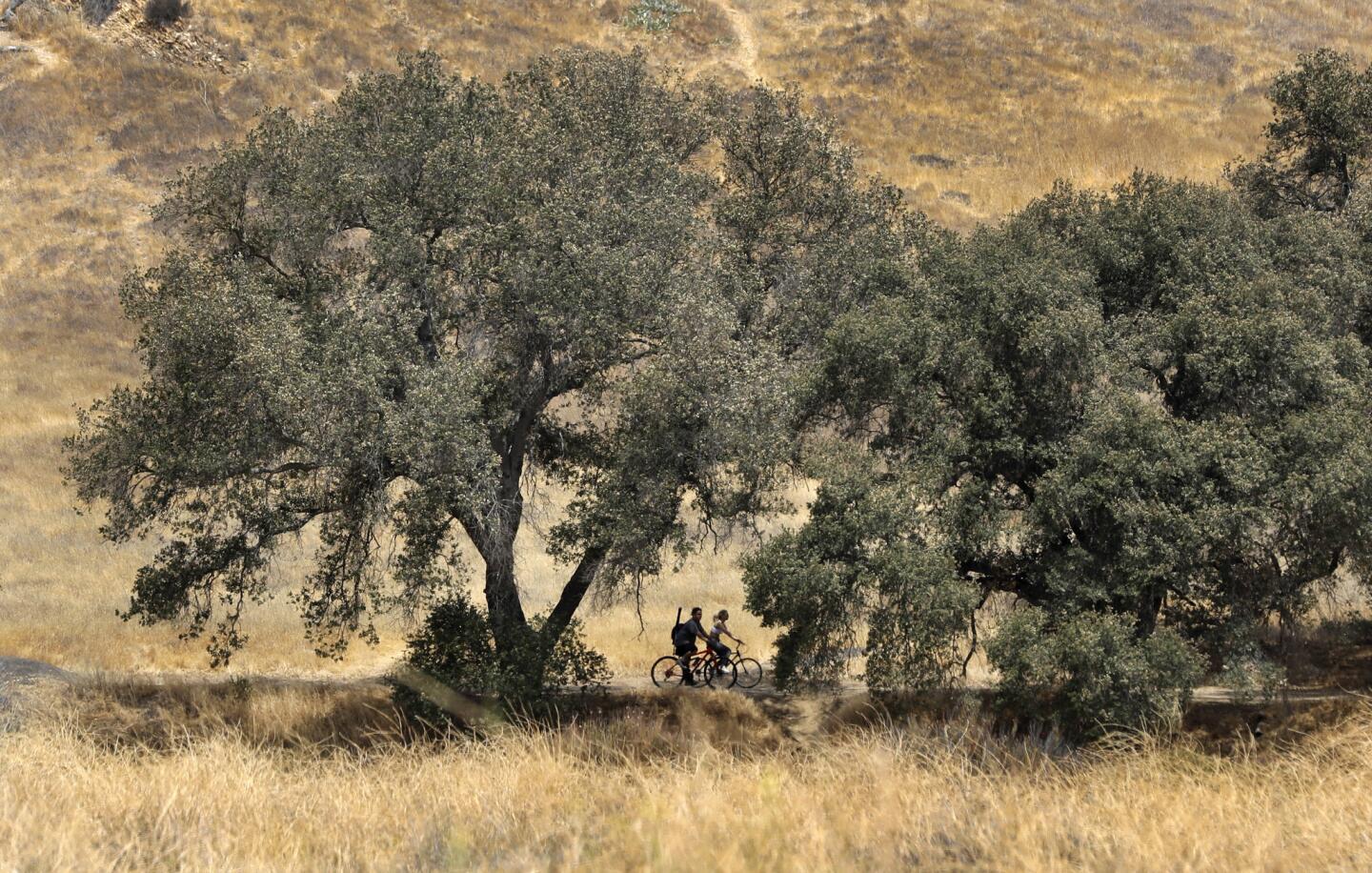 People ride their bikes during a visit to Malibu Creek State Park in Calabasas.