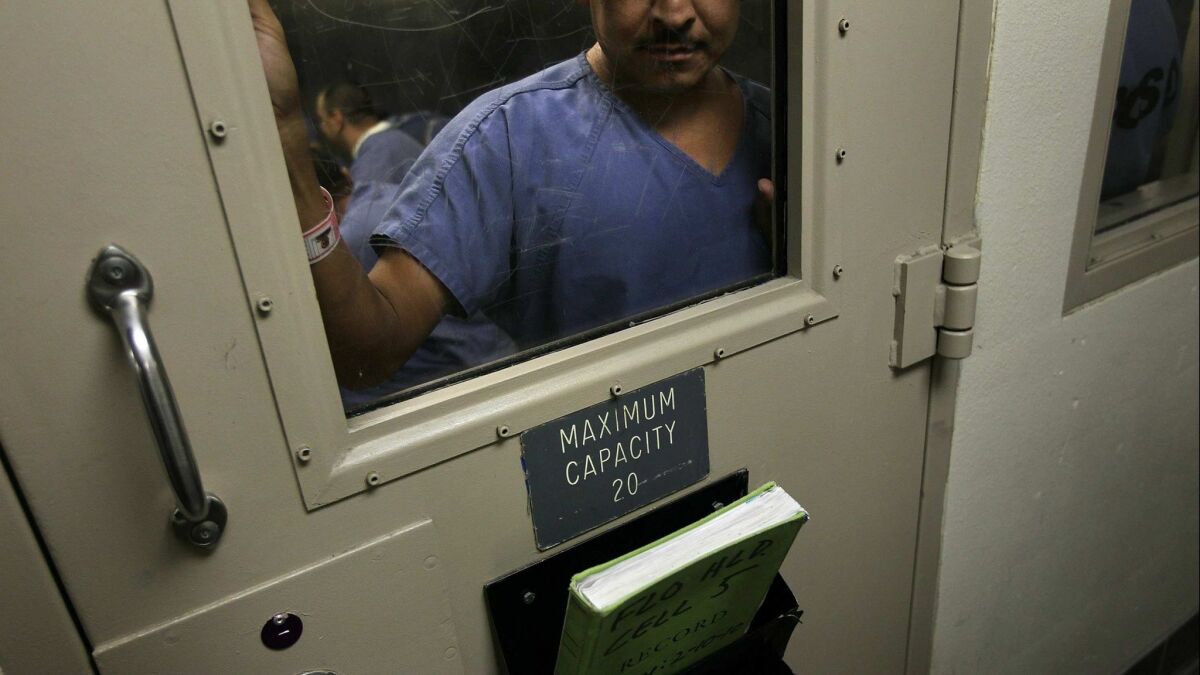 An undocumented immigrant stands in a holding cell at the U.S. Immigration and Customs Enforcement (ICE) detention facility in Florence, Ariz. on July 30, 2010.