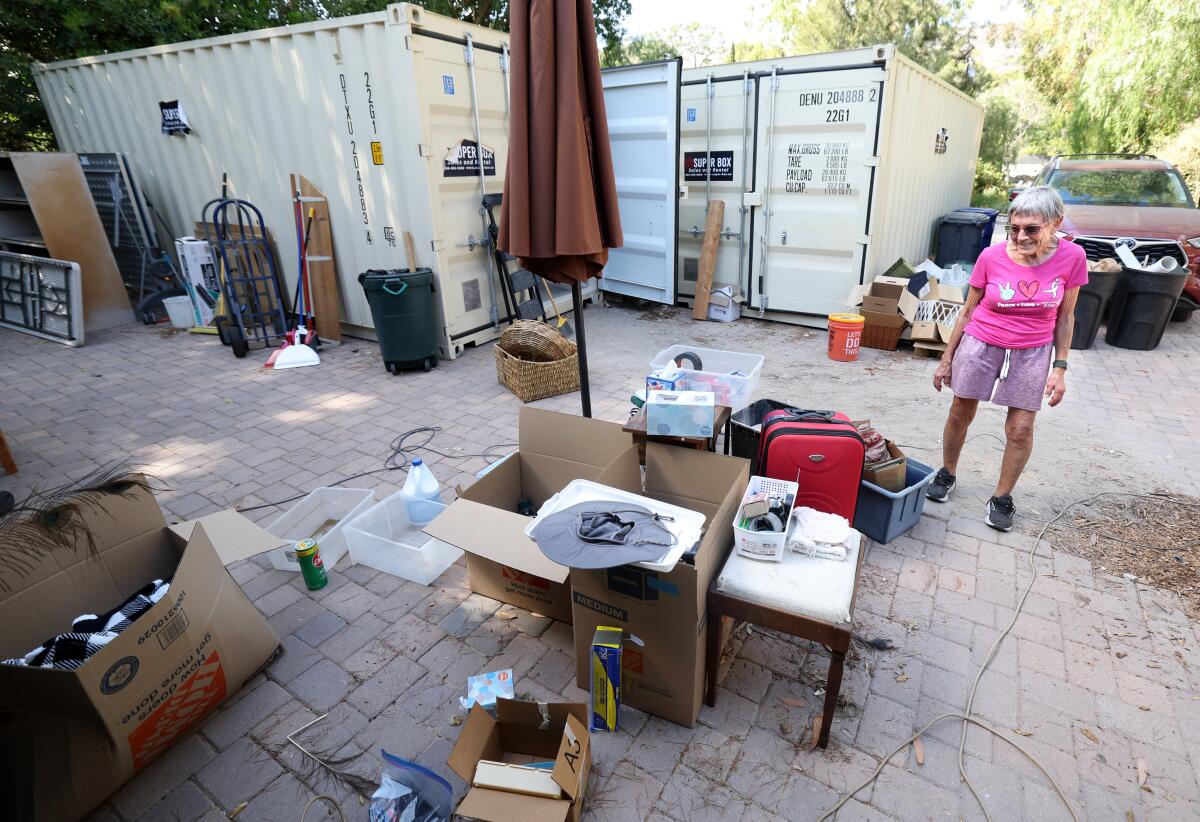 Sallie Reeves surrounded by boxes and belongings