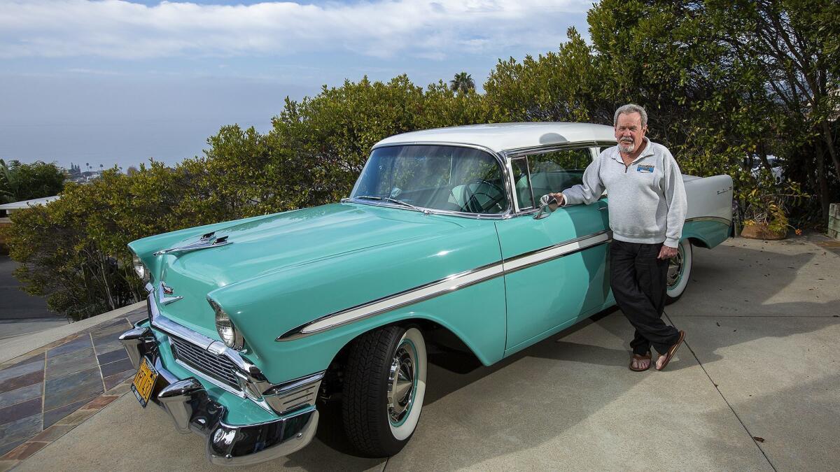 Kelly Boyd, who retired in December after a cumulative 16 years (including the past 12) on the Laguna Beach City Council, poses with his 1956 Chevrolet Bel Air outside his home last month.
