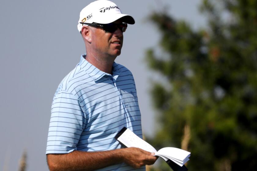Stewart Cink checks his yardage book before playing a shot during the first round of the RSM Classic on Thursday.