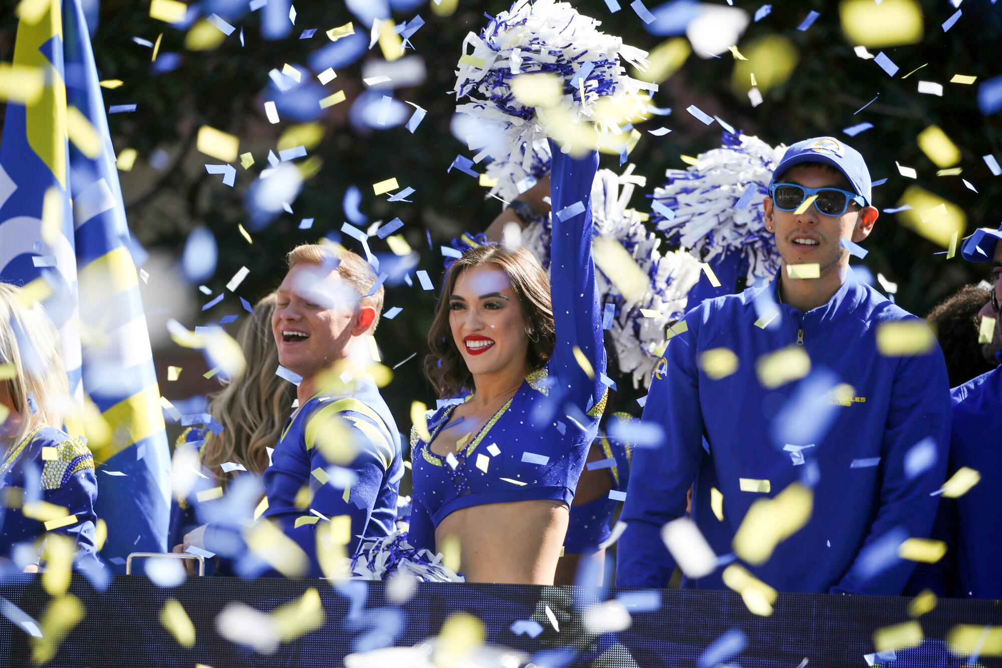Confetti flutters over a Rams cheerleader riding in the Super Bowl victory parade Wednesday morning.