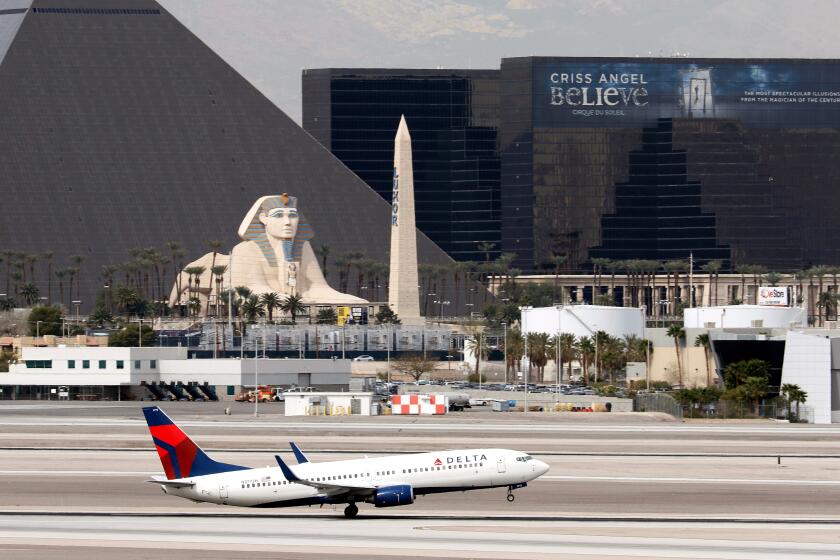 A Boeing 737 (737-800), belonging to Delta Airlines, passes the Luxor Hotel/Casino as it takes off at McCarran International Airport in Las Vegas, Nevada on Mar. 3, 2016. (Larry MacDougal via AP)