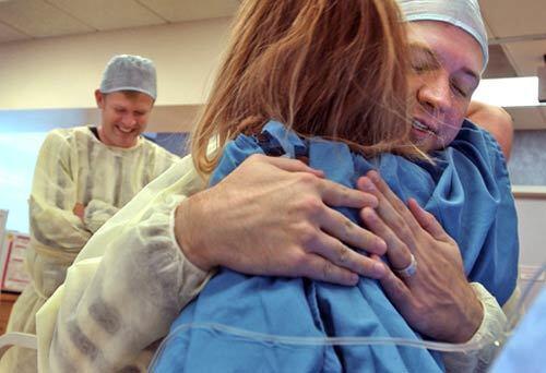 Chad Craig hugs egg donor Jessica after 26 eggs were harvested from her. Chad and David Craig, in the background, had been waiting nearly two years for this moment. It was the first significant medical step in their unconventional quest to become fathers.