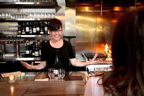 Bartender and server Bree Pavey chats with customers at the Spice Table, a new downtown restaurant.