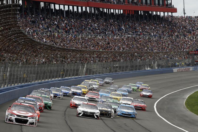 Kyle Larson, front left, takes the lead from the pole position at the start of the NASCAR Cup Series.