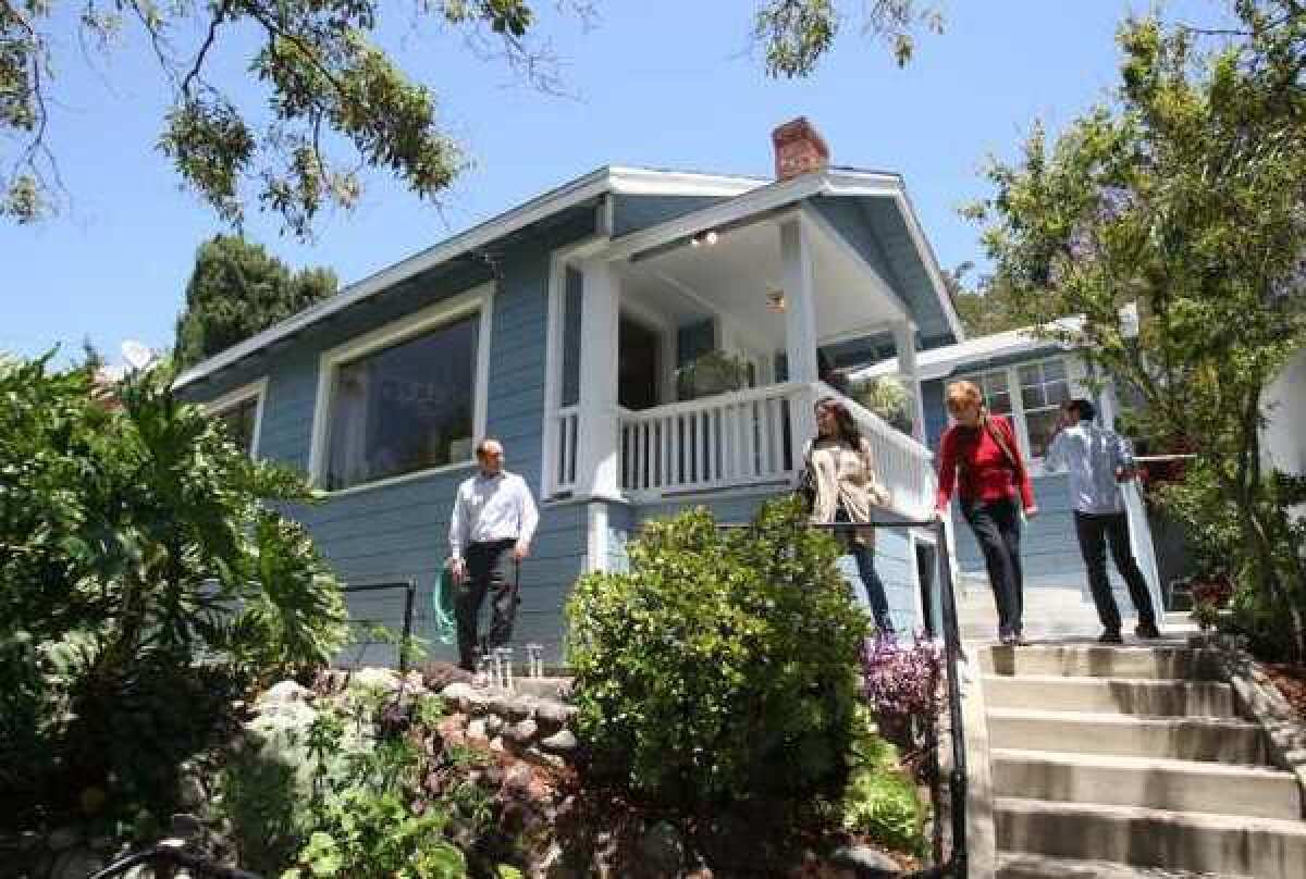 Real estate agents flock to a Highland Park bungalow going on the market earlier this year. The inventory of lower-cost homes, those that sell for $313,200 or less, has continued to shrink this year, leaving entry-level buyers scrambling.