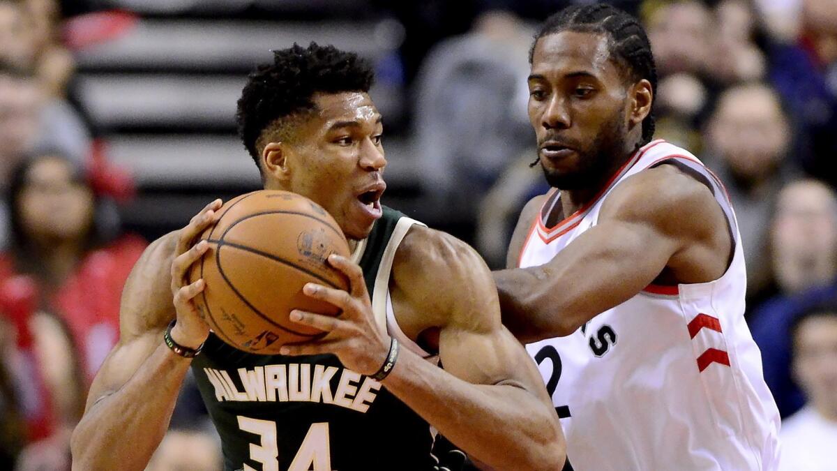 Raptors forward Kawhi Leonard (2) puts pressure on Bucks forward Giannis Antetokounmpo (34) during the second half Sunday.