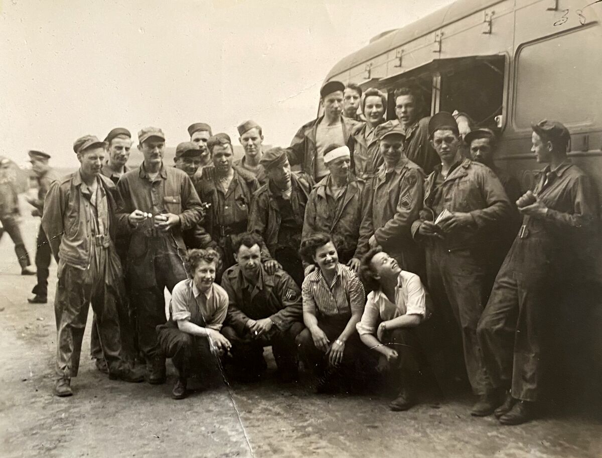 black and white photo of a large group of people crouching down for a photo