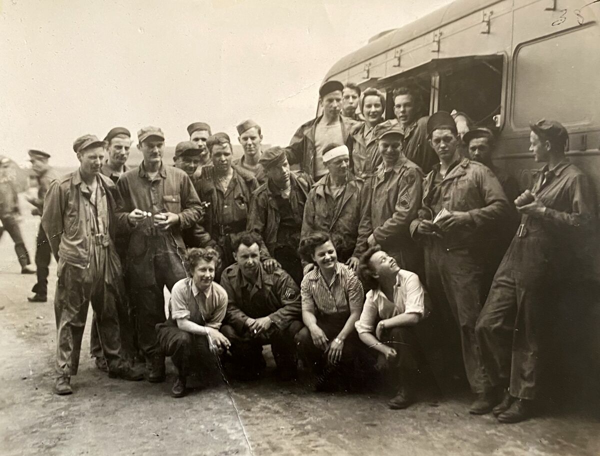 black and white photo of a large group of people crouching for a photo