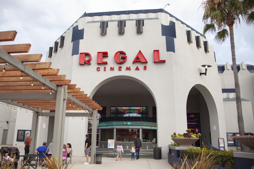 People gather outside the Regal Cinemas on Wednesday at the OceanPlace Entertainment Center in Oceanside.