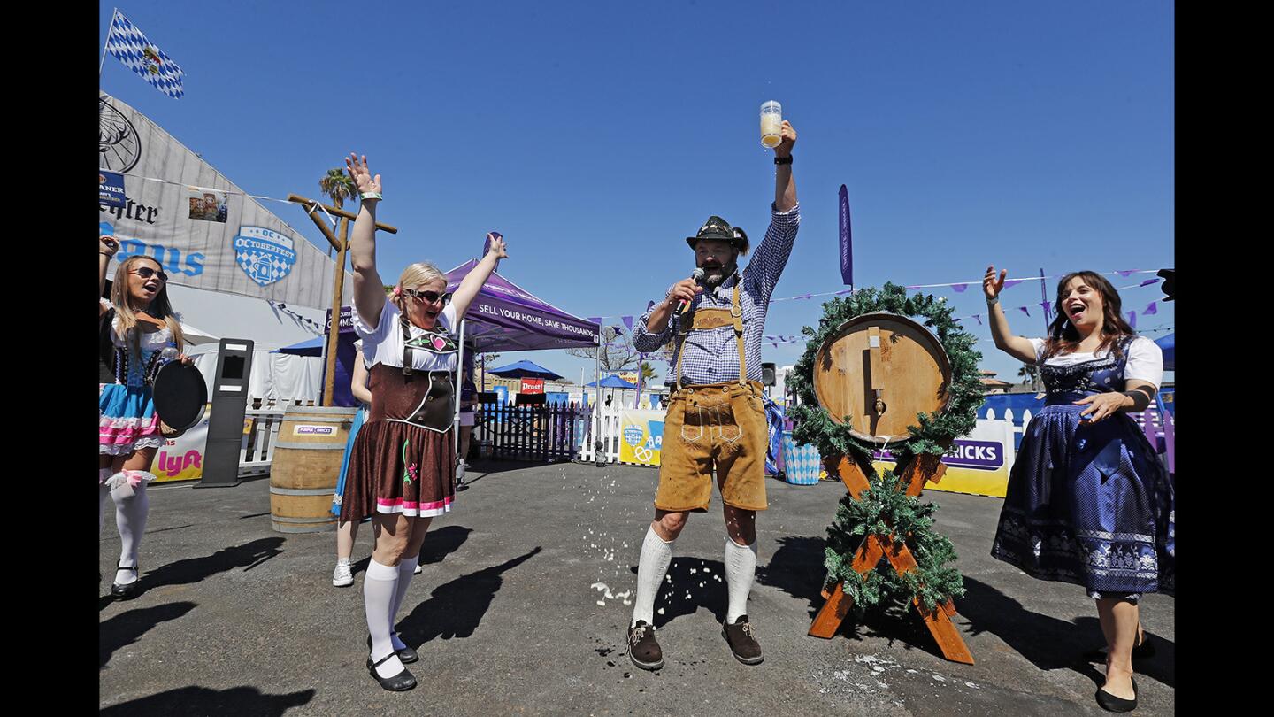 Burgermeister Peter von Melton lifts his pint during a keg tapping ceremony to kickoff the weekend for "OCtoberfest" at Newport Dunes in Newport Beach on Saturday, Sept. 29.