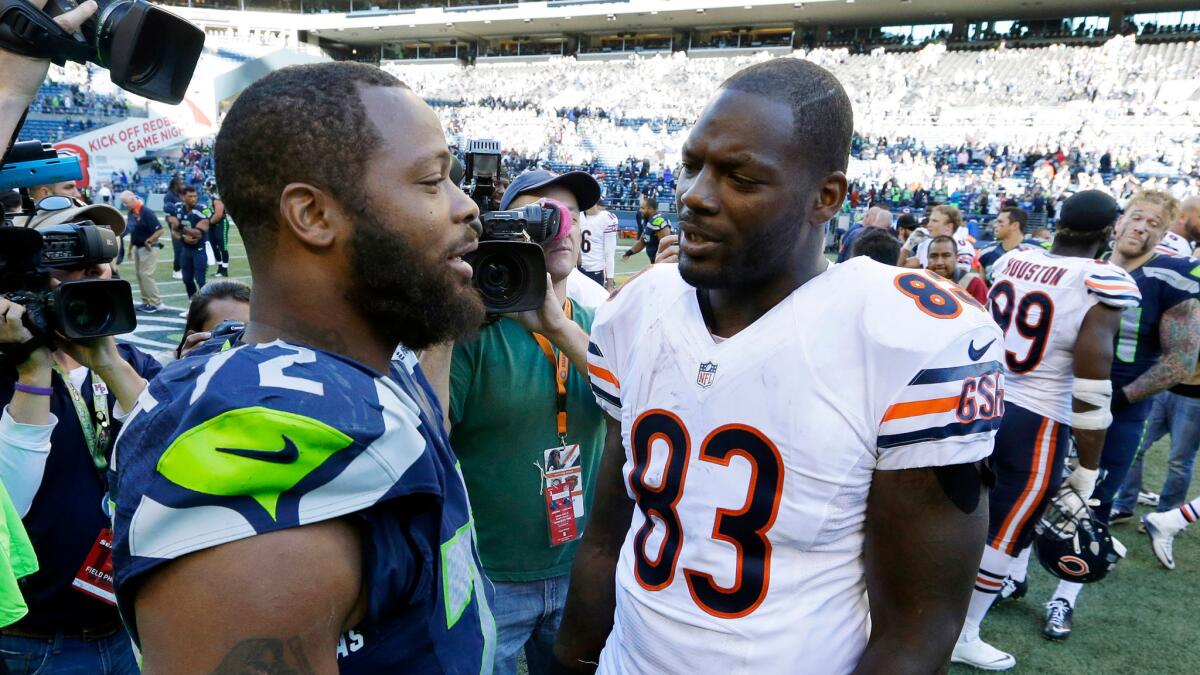 Michael, left, and Martellus Bennett talk the Seattle-Chicago game on Sept. 27, 2015. Michael is a defensive end for the Seahawks; Martellus is now a New England tight end.