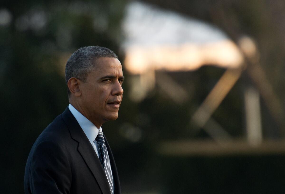 President Obama returns to the White House after traveling to Lansing, Mich.