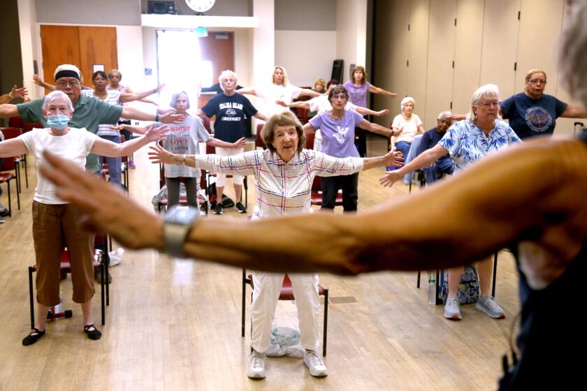 CULVER CITY, CA - JULY 9, 2024 - Instructor Teri Lemoine, 66, foreground, instructs Janie Williams, 94, center, and other seniors during the Balance Challenge Class at the Culver City Senior Center in Culver City on July 9, 2024. (Genaro Molina/Los Angeles Times)