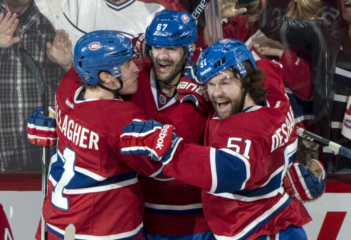 Montreal's Max Pacioretty, center, celebrates with his teammates Bendan Gallagher, left, and David Desharnais after scoring a goal in the second period. The Canadiens beat the Bruins, 4-0, to force Game 7 on Wednesday in Boston.