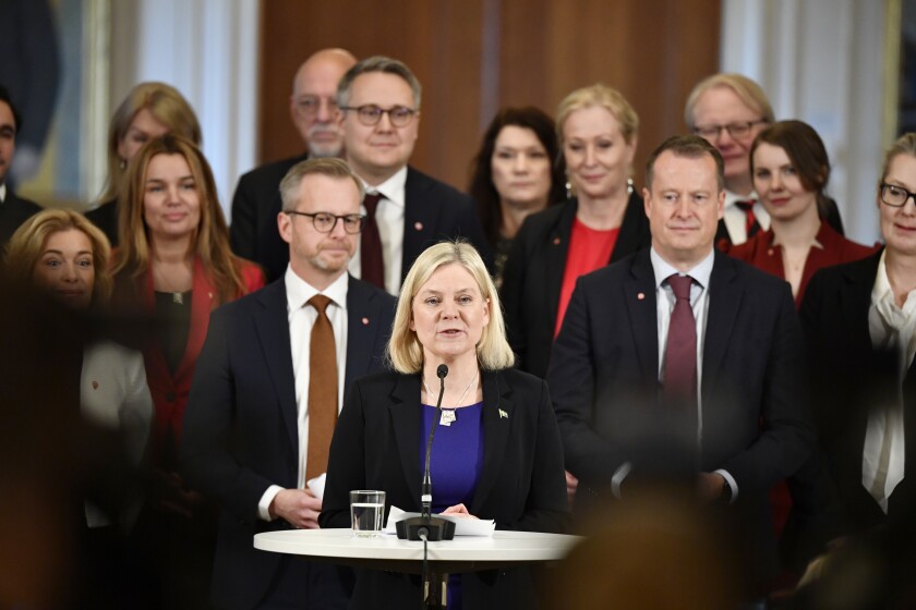 Swedish Prime Minister Magdalena Andersson, center, with her new cabinet members behind her, speaks during a press conference, in Stockholm, Tuesday, Nov. 30, 2021. Andersson, the first woman to ever hold that post in Sweden, has presented her one-party, minority government with only few changes compared to the previous one. (Soeren Andersson/TT via AP)