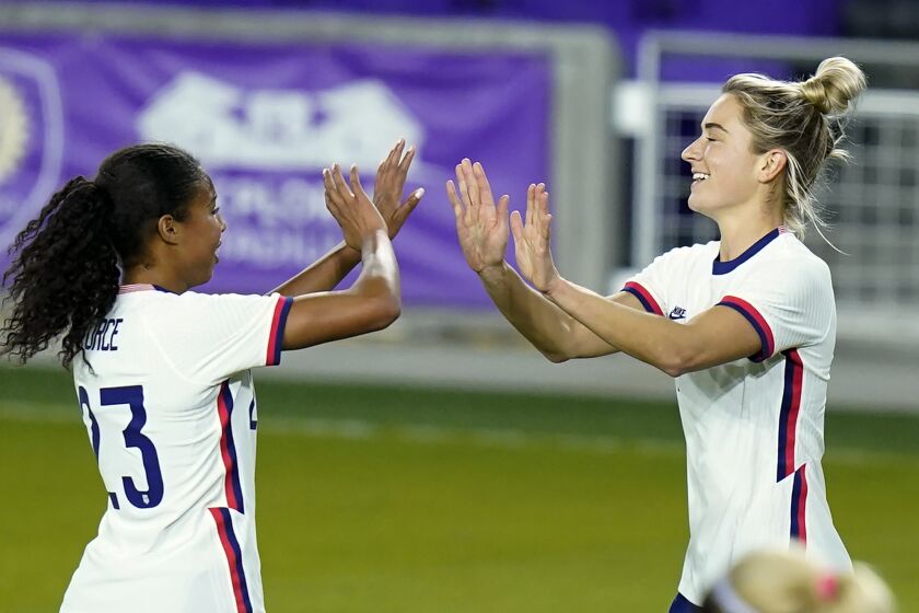 United States midfielder Kristie Mewis, right, celebrates her goal against Colombia with defender Margaret Purce.