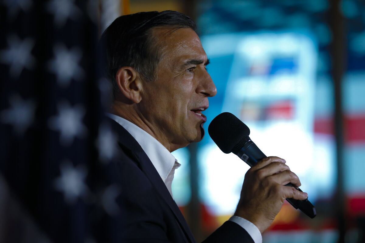 Darrell Issa holds a microphone