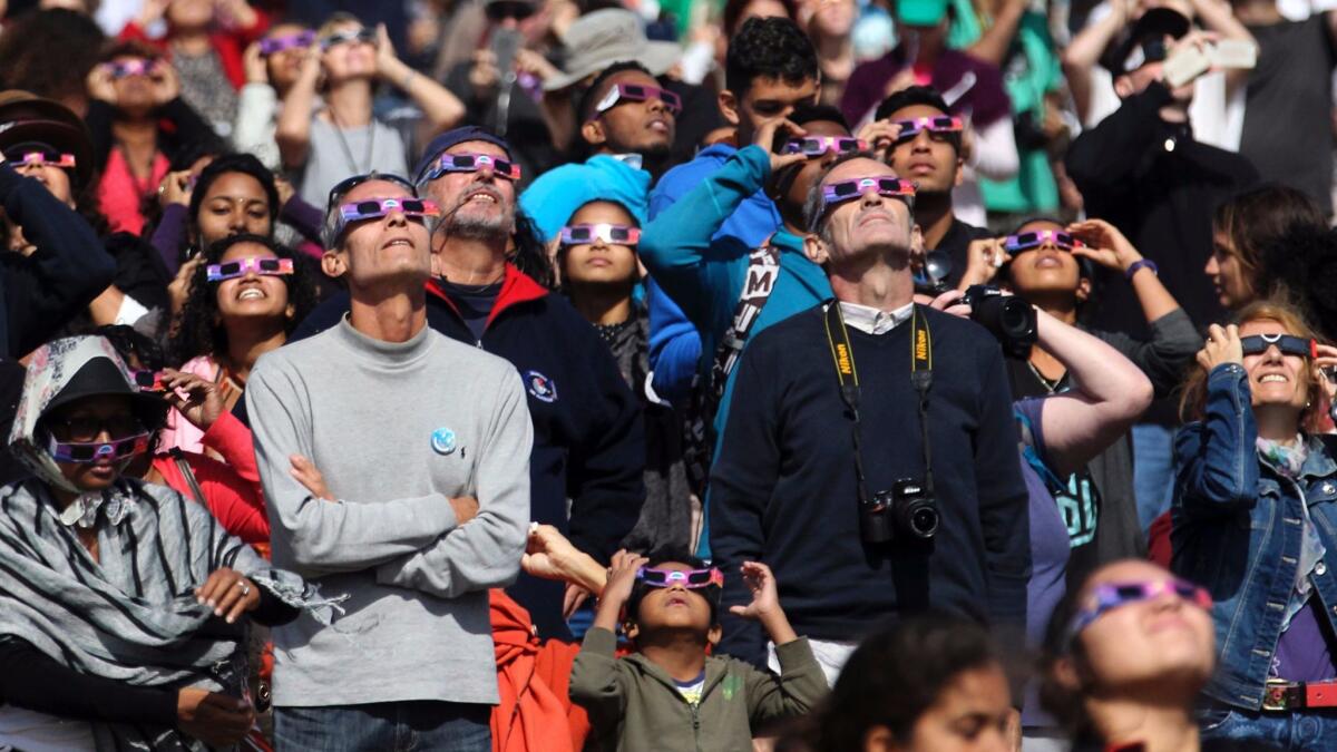 Eclipse enthusiasts say it's worth taking a moment to watch others watch an eclipse. (Richard Bouhet / AFP/Getty Images)