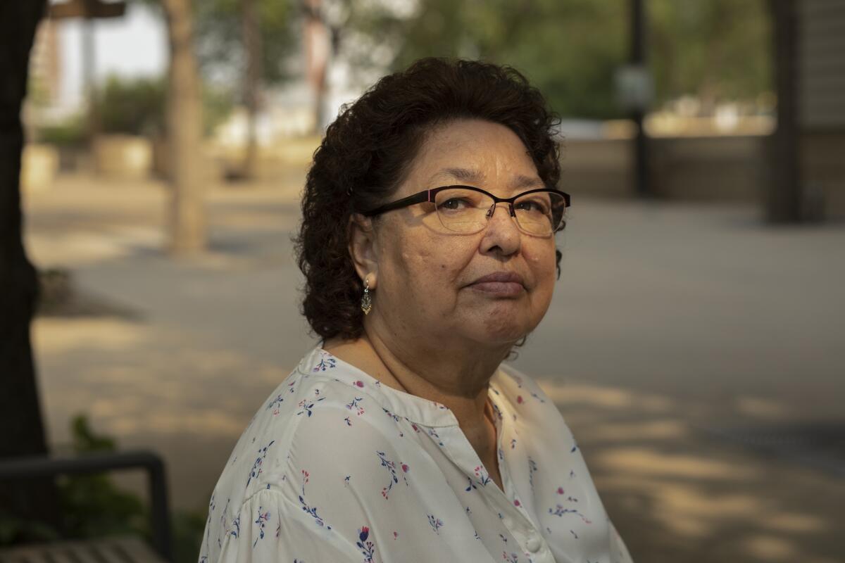 May Sarah Cardinal sits for a portrait outside the Law Courts building in Edmonton, Alberta, Canada