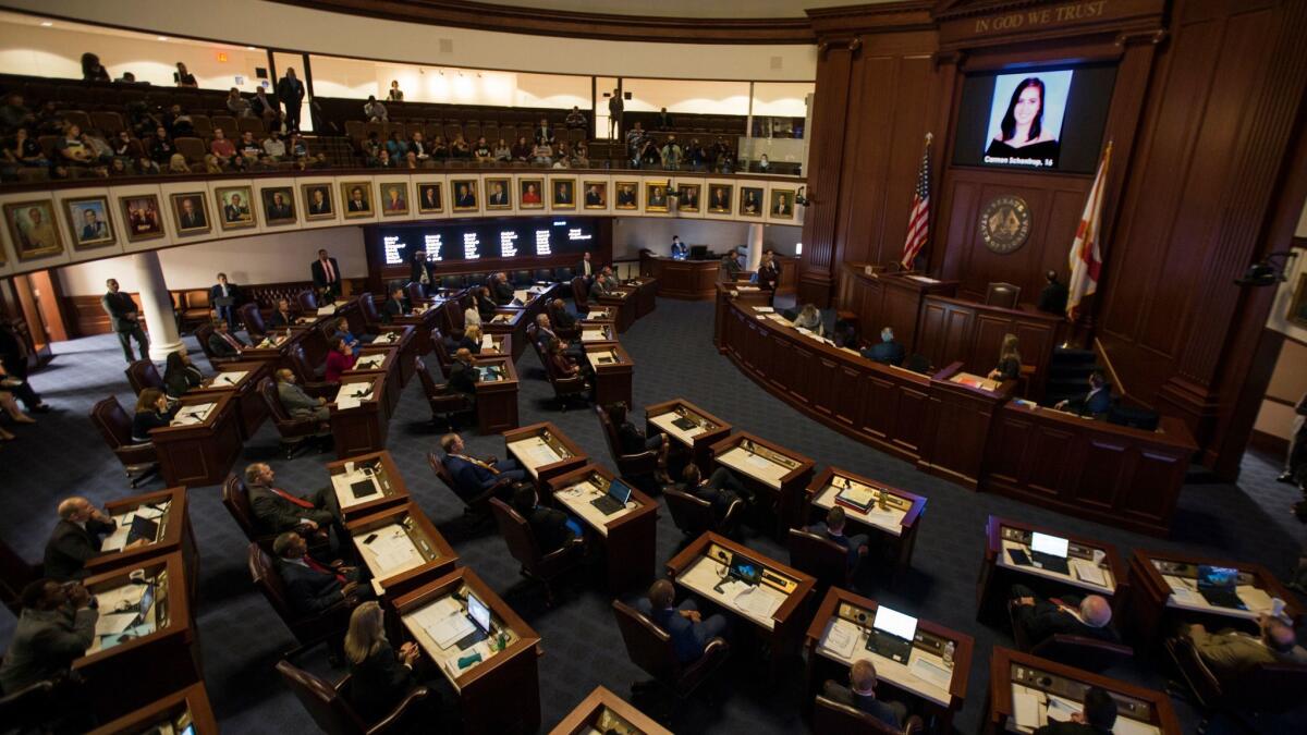 A slideshow in the Florida Senate chamber on Feb. 21, 2018, shows each person killed in a shooting at Marjory Stoneman Douglas High School.