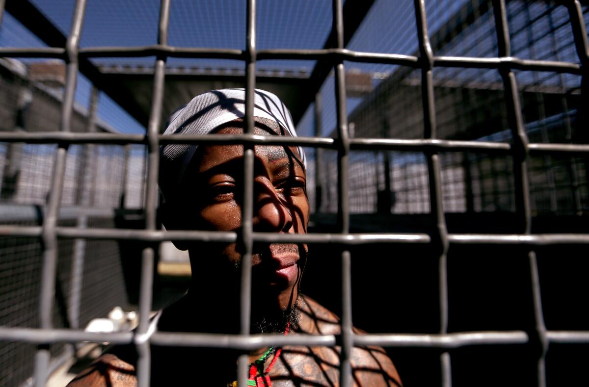A man exercises in an outdoor cage at California State Prison, Sacramento