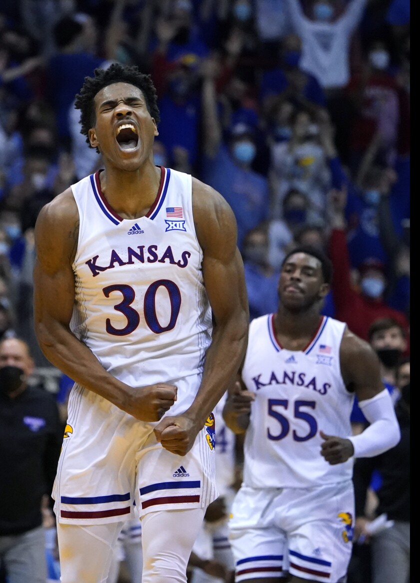 Kansas guard Ochai Agbaji (30) reacts after hitting a three point shot in the second half of an NCAA college basketball game against Iowa State Cyclones Tuesday, Jan. 11, 2022, in Lawrence, Kan. Kansas won 62-61. (AP Photo/Ed Zurga)
