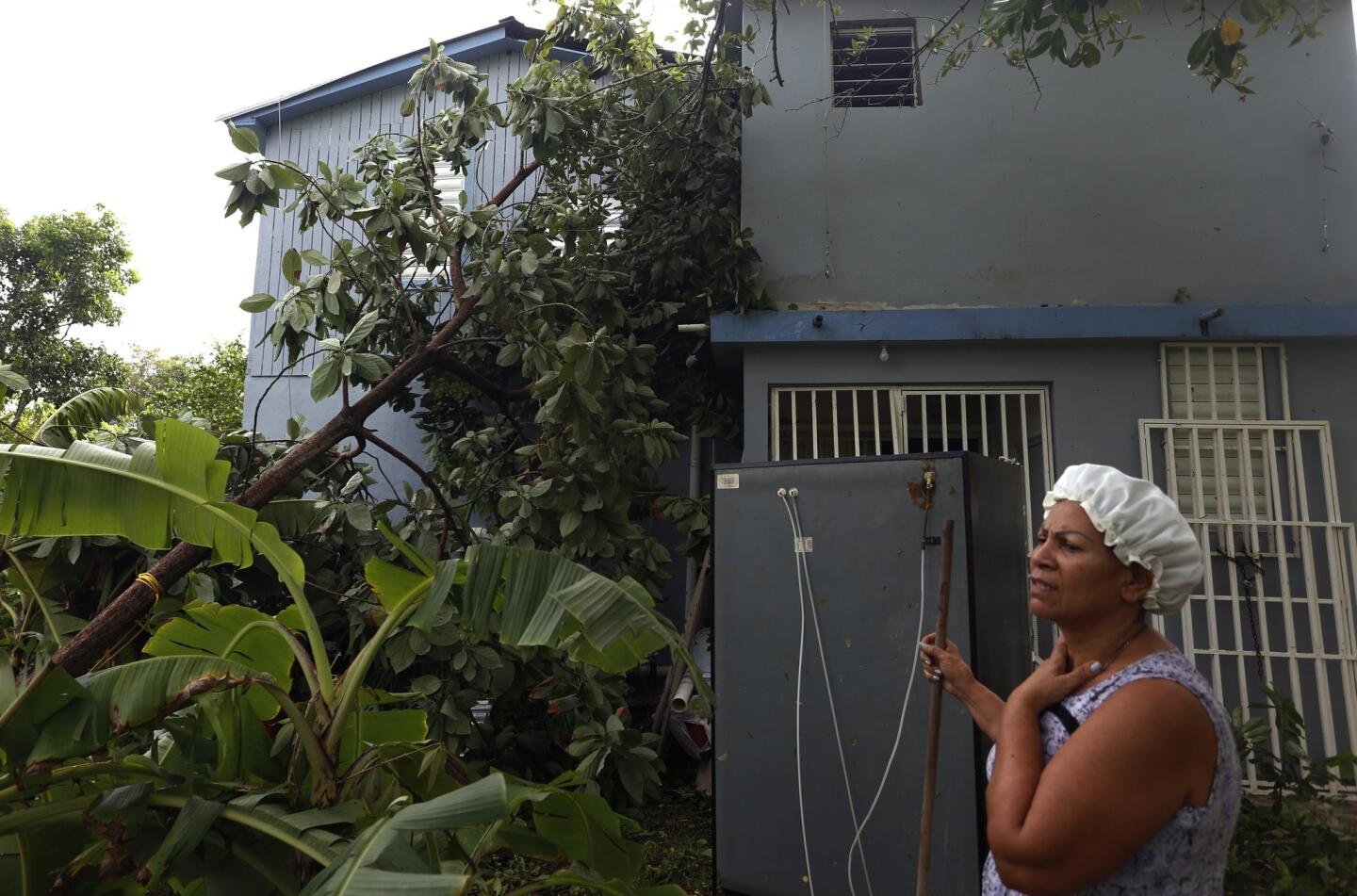 A woman cleans her house in the aftermath of Hurricane Irma, in San Juan, Puerto Rico, September 7, 2017.