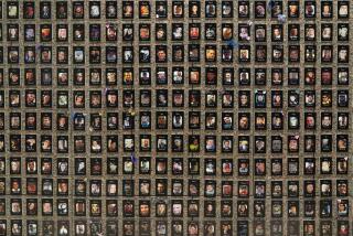 Photographs of people who had died from drugs are on display during the Second Annual Family Summit on Fentanyl at DEA Headquarters in Washington, Tuesday, Sept. 26, 2023. (AP Photo/Jose Luis Magana)