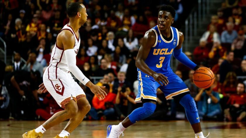 UCLA Bguard Aaron Holiday (3) is defended by USC guard Jordan McLaughlin (11) during a game at the Galen Center on Saturday.