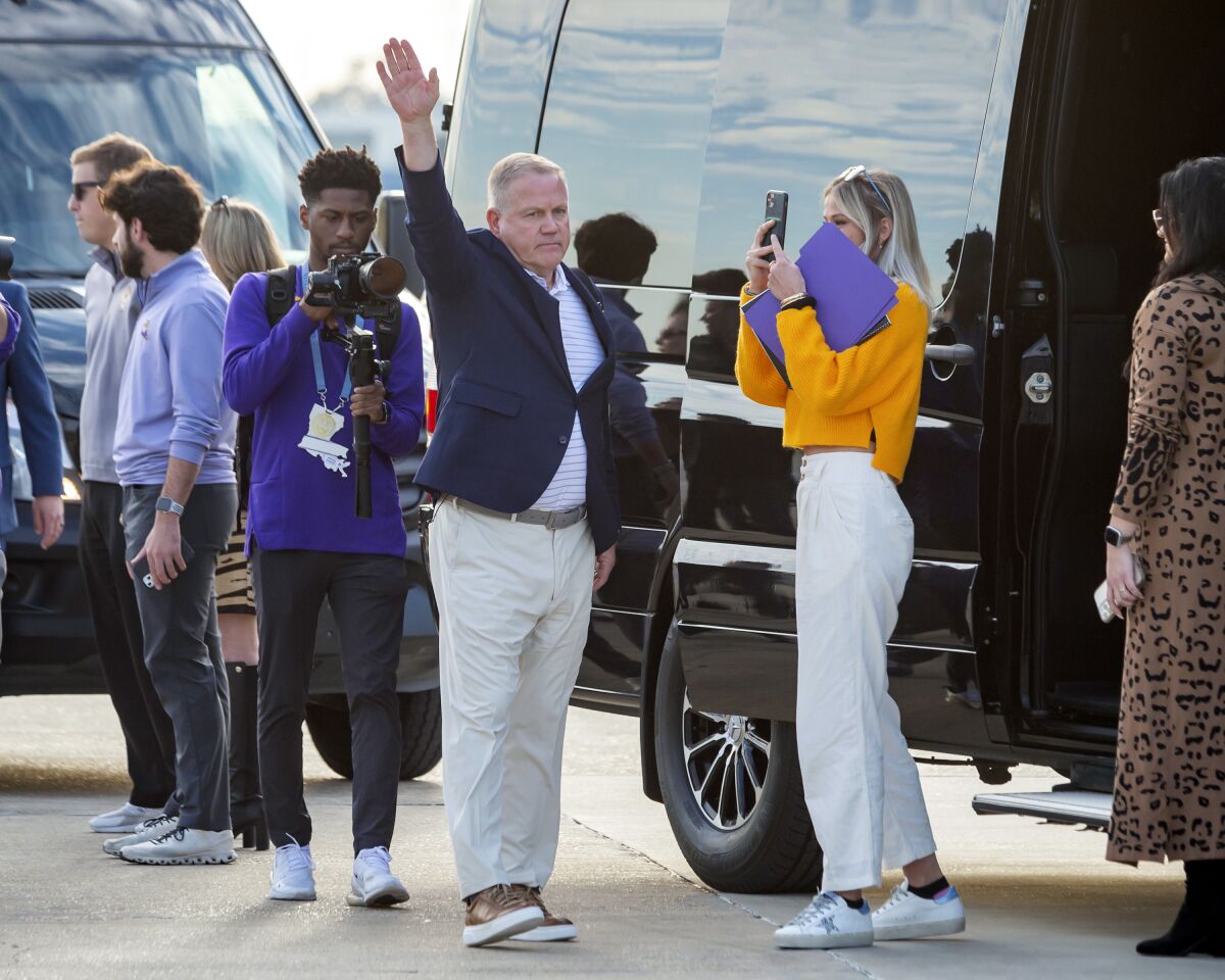 New LSU football coach Brian Kelly waves to fans after his arrival at Baton Rouge Metropolitan Airport, Tuesday, Nov. 30, 2021, in Baton Rouge, La. Kelly, formerly of Notre Dame, is said to have agreed to a 10-year contract with LSU worth $95 million plus incentives. (Scott Clause/The Daily Advertiser via AP)