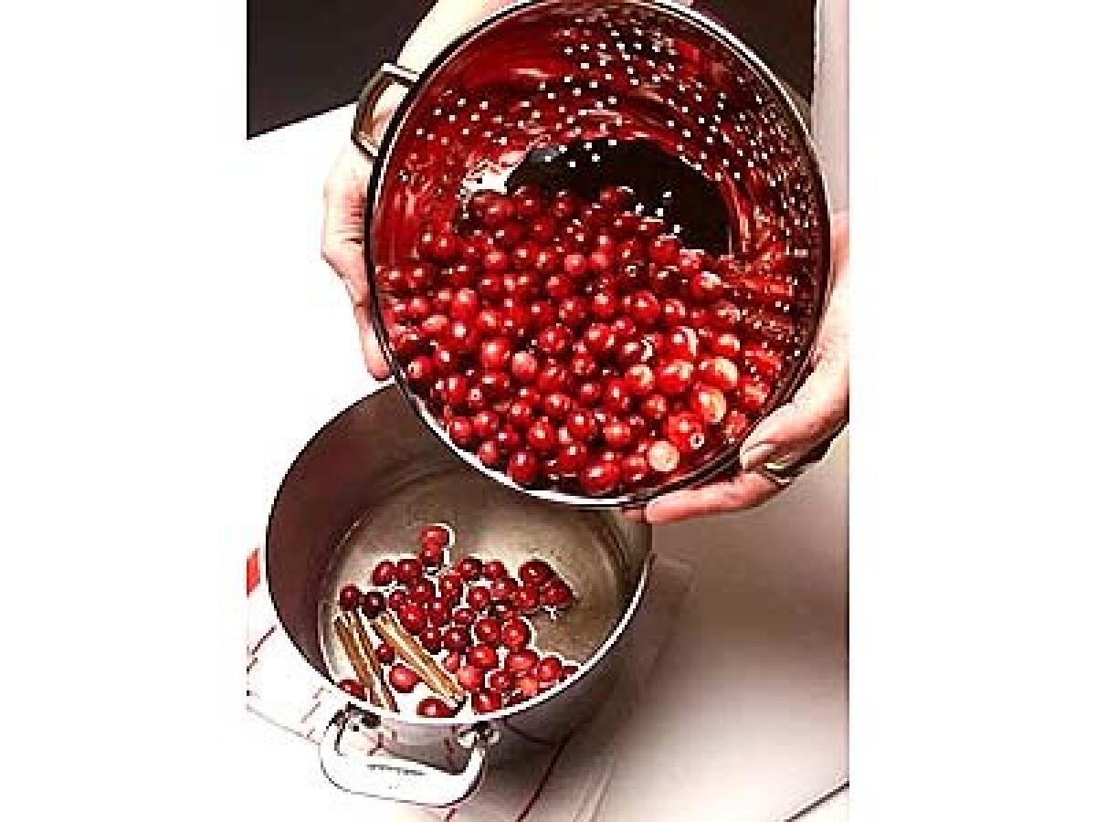 Add cranberries to boiling syrup. Cook cranberries until they begin to pop, then remove from heat.