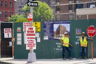 Construction workers help direct traffic outside a residential and commercial building under construction at the Essex Crossing development on the Lower East Side of Manhattan, Thursday, Aug. 4, 2022. On Friday, Aug. 5, the Labor Department delivers its July jobs report. (AP Photo/Mary Altaffer)