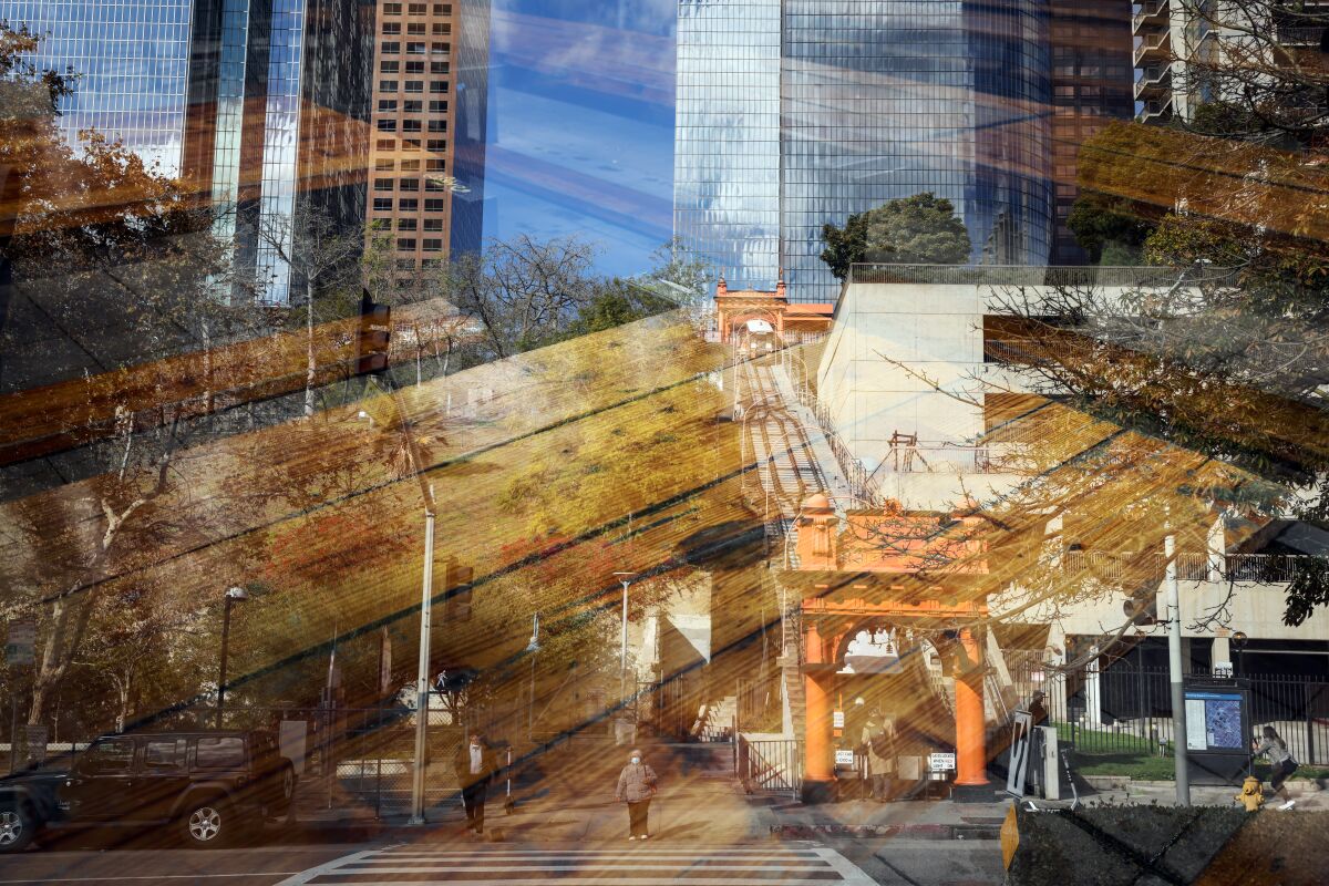 An open-air picnic tables in front of Horse Thief BBQ and the view of Angels Flight is seen in a double exposure.