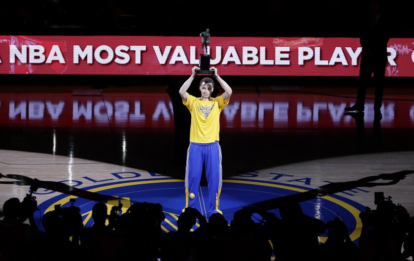 FILE - Golden State Warriors guard Stephen Curry acknowledges the crowd during a ceremony for winning the NBA's Most Valuable Player award before Game 2 in a second-round NBA playoff basketball series between the Warriors and the Memphis Grizzlies, May 5, 2015, in Oakland, Calif. (AP Photo/Jeff Chiu, File)