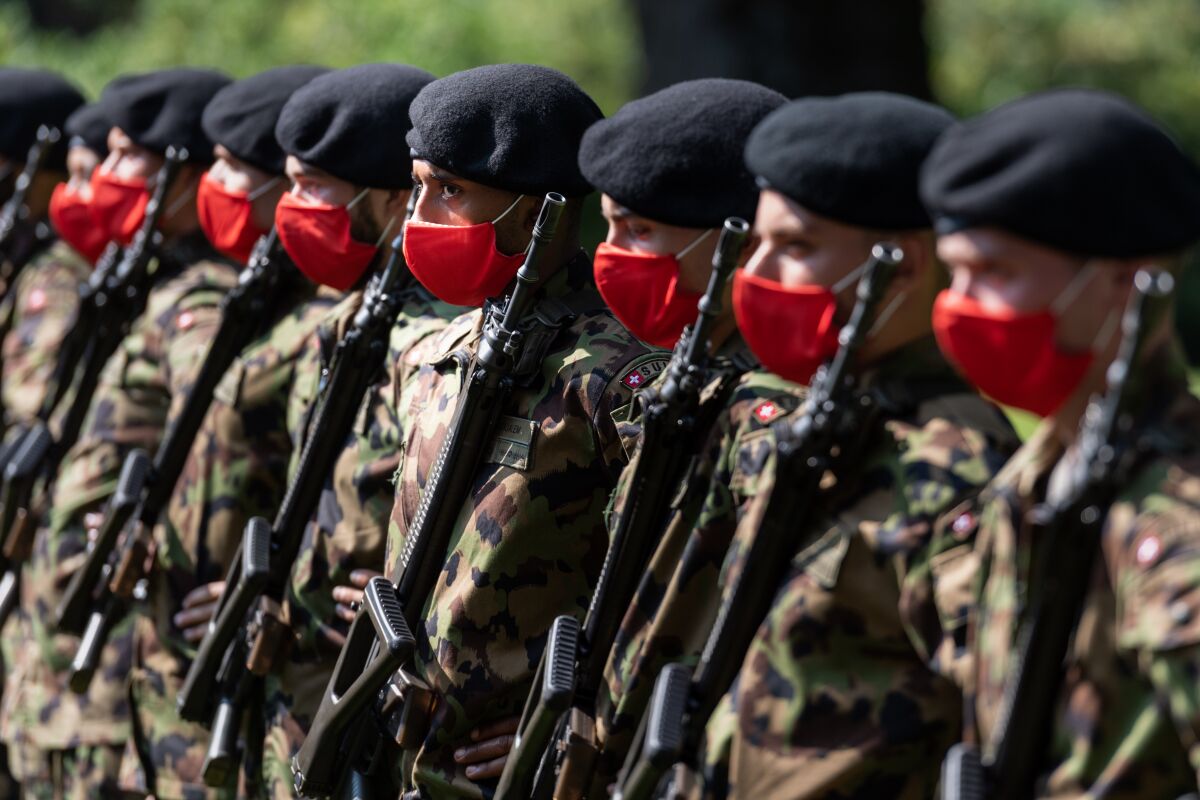 FILE - The guard of honour of the Swiss Army stands ready for the arrival of Austrian Chancellor Sebastian Kurz at the Lohn residence of the Swiss government in Kehrsatz, Switzerland, Sept. 18, 2020. The Swiss army has ordered its ranks to stop using foreign instant-messaging services like WhatsApp, Signal and Telegram for official communications, opting for a Swiss alternative in part over concerns about legislation in Washington that governs how U.S. authorities can access information held by tech companies. Army leaders called for use of the Swiss instant messaging service Threema, and a promotion for the service was posted Dec. 29, 2021 on the Swiss army’s page on Facebook — which, like WhatsApp, is owned by the U.S. company now known as Meta. (Alessandro della Valle/Keystone via AP, file)