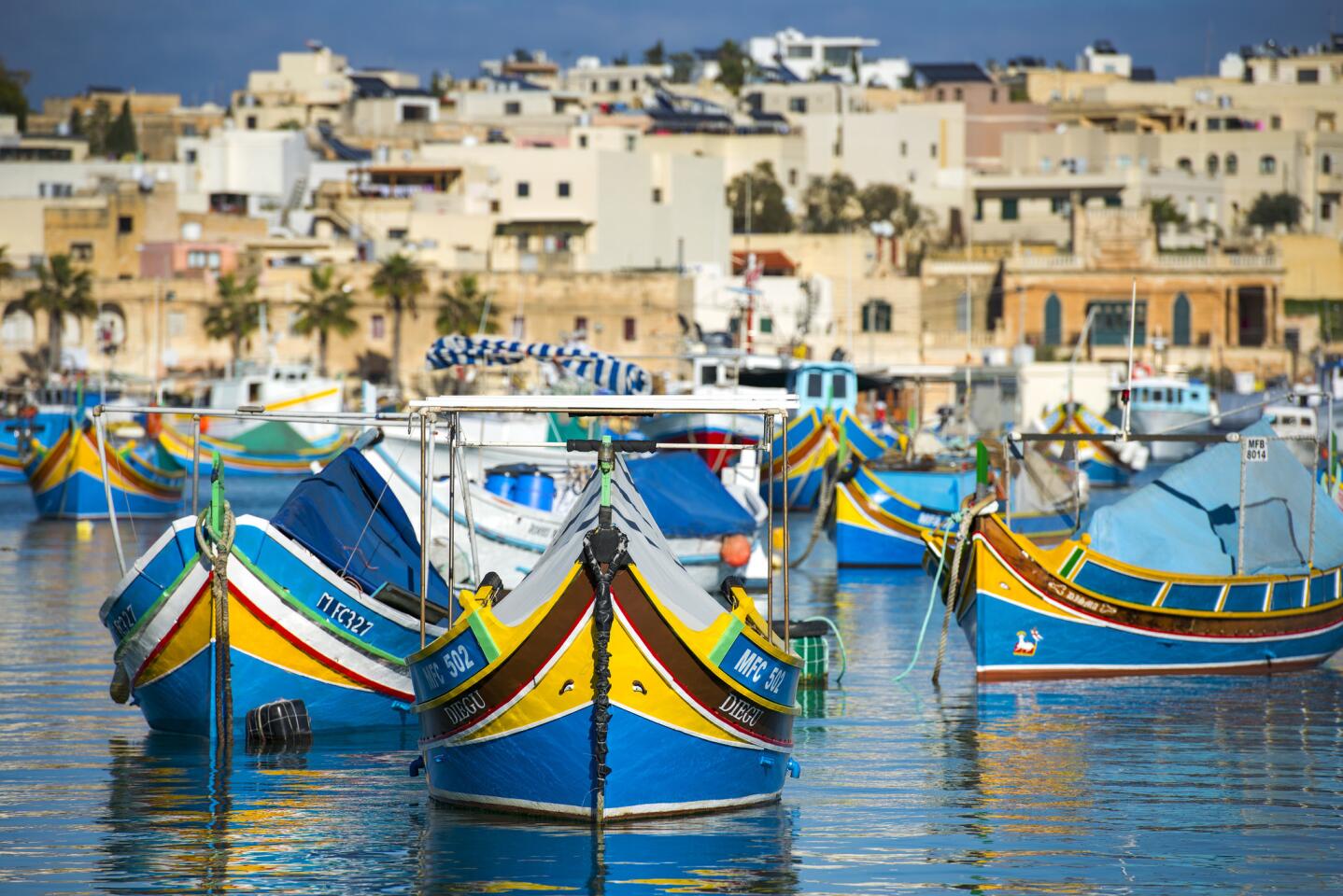 Colorful fishing boats in Marsaxlokk harbor.