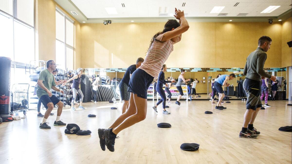 People participate in the Spartan Strong workout at the Life Time Athletic club on Dec. 13, 2018, in Laguna Niguel.