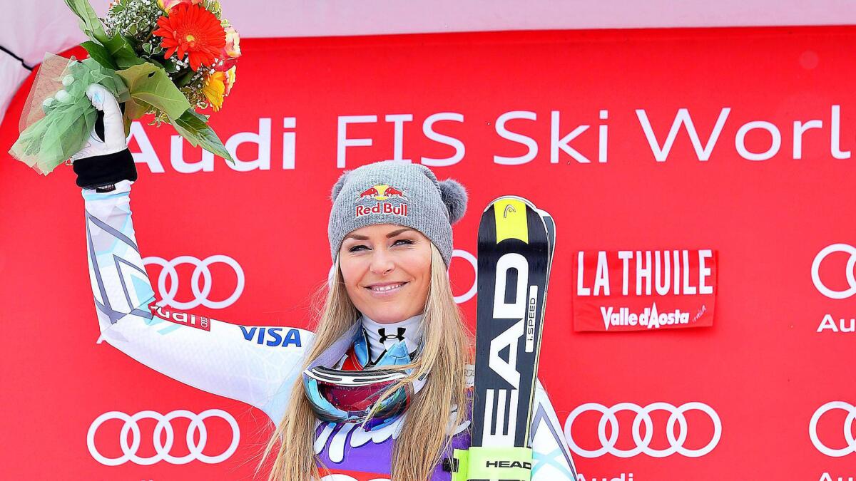 Lindsey Vonn celebrates on the podium after taking second place in the women's downhill race La Thuile, Italy, on Saturday to clinch the World Cup season title.