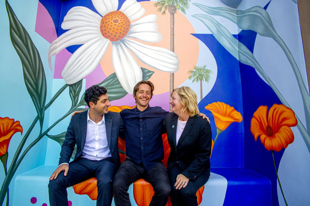 Triangle Square owner Tyler Mateen with artist Aaron Glasson and Costa Mesa Mayor Katrina Foley in 2019.