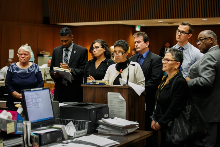 L.A. County social workers Patricia Clement, left, and Stefanie Rodriguez, third from left, are arraigned in Los Angeles along with their respective supervisors, Gregory Merritt, fourth from right, and Kevin Bom, second from right.