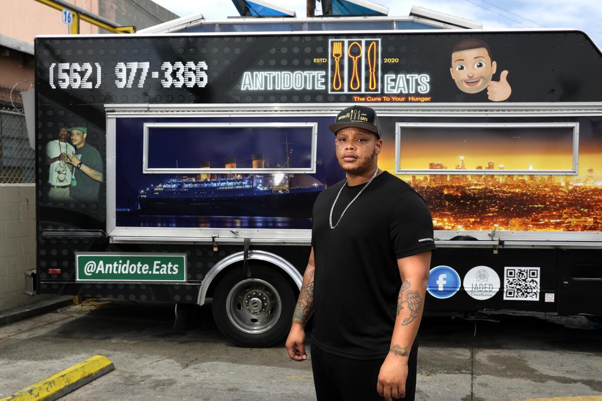 Anthony Suggs stands in front of his food truck, Antidote Eats.