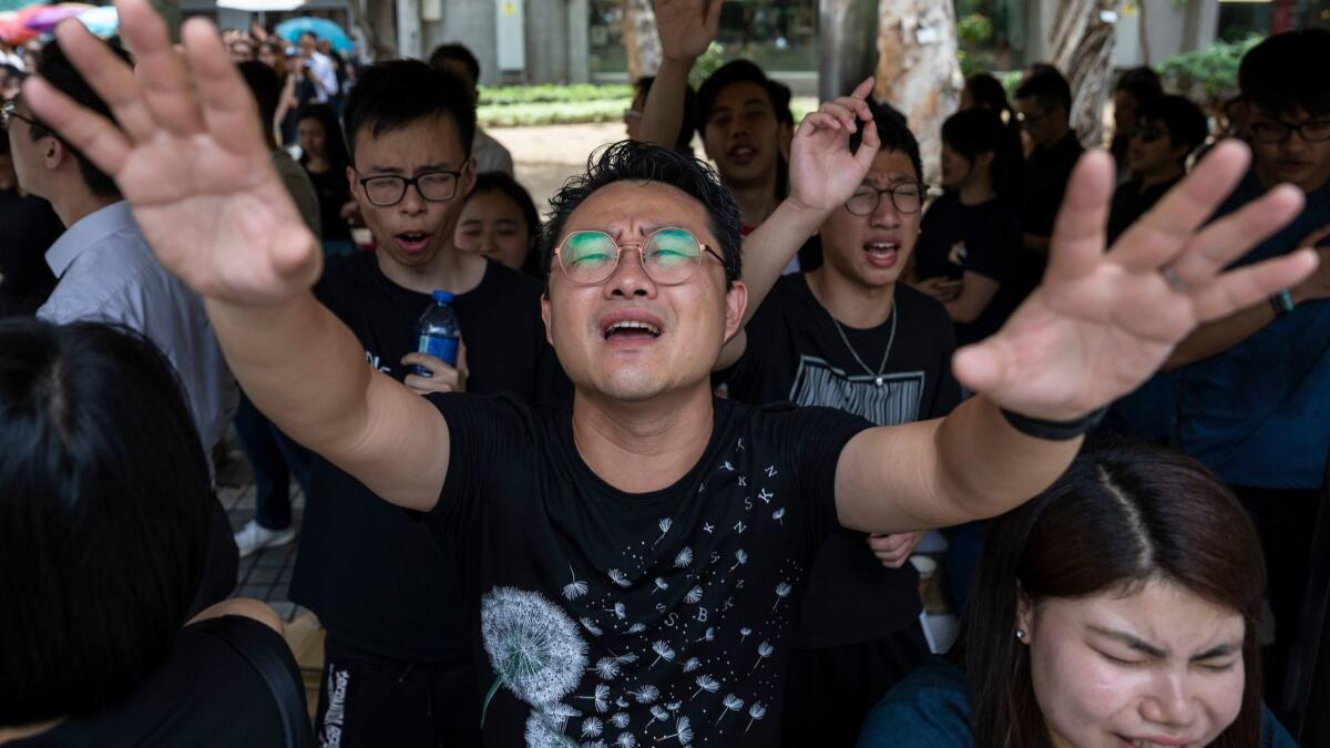 A group of Christian worshippers sing hymns to voice their opposition to an extradition law in Hong Kong, China, June 14, 2019.
