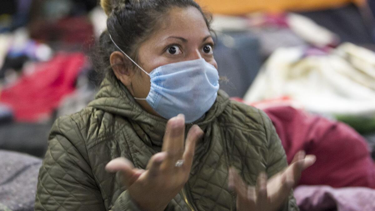 San Diego resident Amy Tillman, off camera to right, spoke with Honduran caravan member Paola Martinez with American Sign Language about her journey from Honduras to Tijuana and the circumstances that forced her to flee her native country.