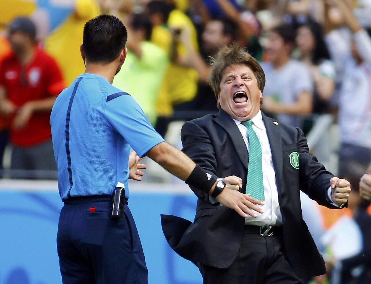 Mexico's coach Herrera celebrates after Dos Santos scored a goal against the Netherlands during their 2014 World Cup round of 16 game at the Castelao arena in Fortaleza